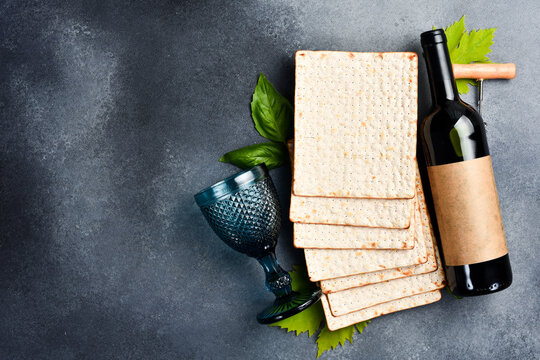 Kosher wine and Matzoh jewish bread. Top view, on a gray background.