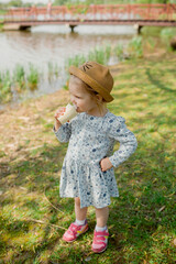 little girl in the park eating ice cream