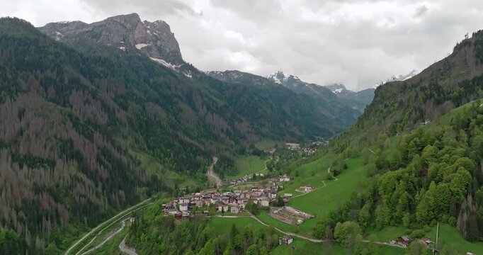 Aerial view Rocca Pietore italy cityscape. The city at the foot of the peaks and mountain ranges in the Dolomite Alps. High quality 4k footage