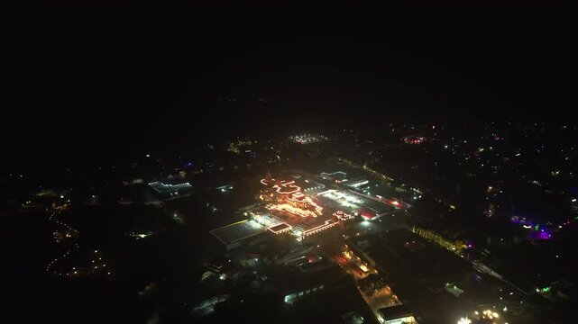 Aerial night view of Ayodhya Ram Temple a brightly illuminated temple complex surrounded by a darkened cityscape. Uttar Pradesh, India