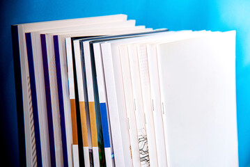 stack of magazines on wall blue isolated