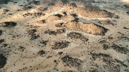 Expansive aerial view of Iona National Park showcasing vast arid landscapes and rocky formations in Angola during daylight