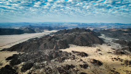 Aerial view of the rugged landscape in Iona National Park, Angola under a textured sky