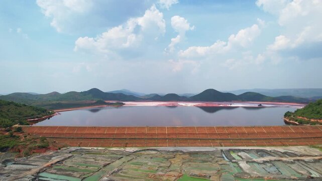 Aerial Top view of red mud pond in Koraput, Odisha. It features structured embankments and compartmentalized ponds, likely part of an industrial or mining site.