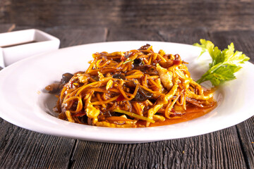Szechuan Chicken Stir Fry  on wood table. Chinese food.