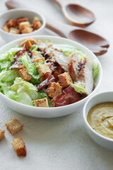 A bowl  of  Caesar salad