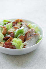 A bowl  of  Caesar salad