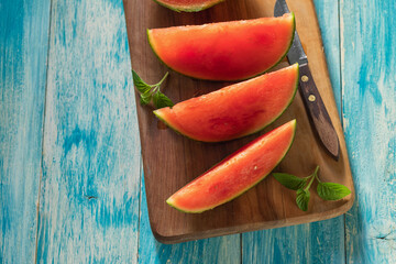 Fresh ripe sliced watermelon on a wooden background