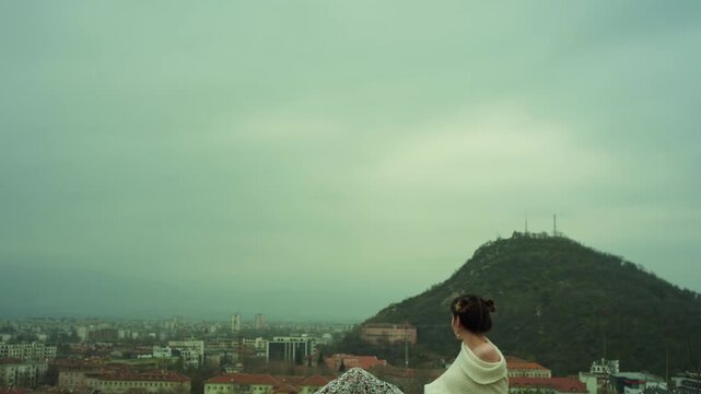 Girl looking on the mountain scape