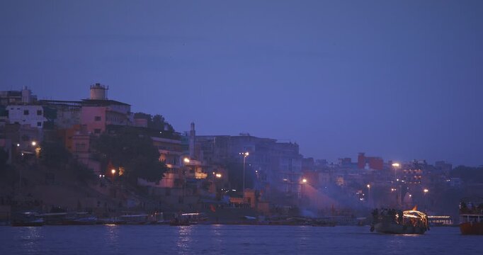 Varanasi, India. General View On Hanuman, Karnataka Ghat, Harishchandra Ghat, Lali Ghat, Vijayanagaram Ghat. Violet Blue Sunset Sky At Evening Time. Cinematic Camera Moving Along Riverbank Embankment
