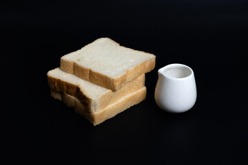 Three slices of whole wheat bread on a white and black background