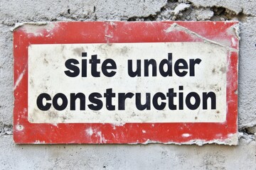 Obraz premium Creative Site Under Construction Sign for Websites on Solid White Background