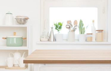 Blank wooden table top part in blurred kitchen interior background