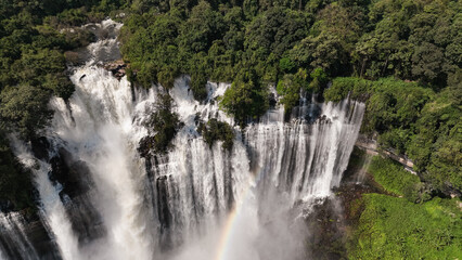 Kalandula Waterfall cascades magnificently in Angola surrounded by lush greenery and a vibrant rainbow above
