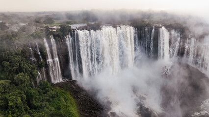 Fototapeta premium Kalandula Waterfall cascading majestically in Angola amid lush greenery during daylight hours