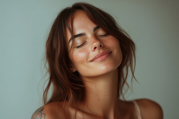 Fototapeta premium A close up of a woman's face with tattoos and her eyes closed
