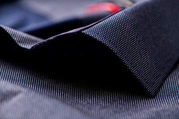 Close up of dark Men's shirt. Soft focus. Copy space.	