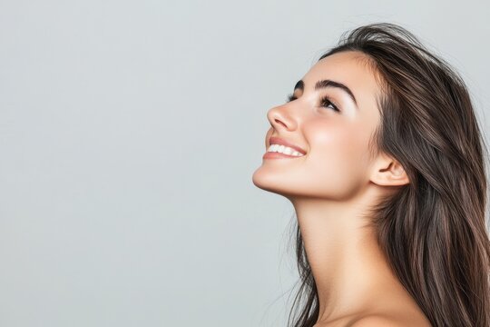 Isolated on a transparent background, this portrait shows a beautiful woman with a smile and looking upwards