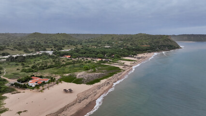 Aerial view of the lush green coast of Angola showcasing the shoreline and surrounding hills
