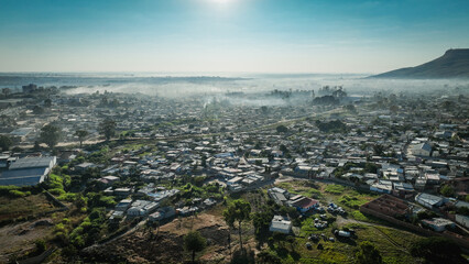 Aerial view of Lubango City in Angola during early morning with fog over the landscape