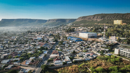 Fototapeta premium Aerial view of Lubango City showcasing urban development and mountainous landscape in Angola