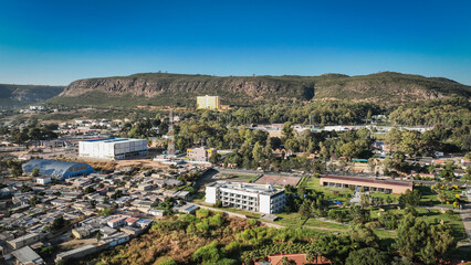 Obraz premium Aerial view of Lubango City showcasing urban scenery and mountainous backdrop in Angola