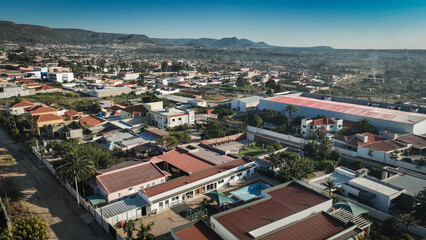 Fototapeta premium Aerial view of Lubango City showcasing residential areas and surrounding mountains in Angola