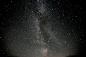 beautiful milky way in night sky with shooting star