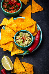 Traditional Mexican food nachos, salsa, guacamole, tequila.