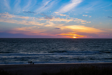 Sunset on the beach of Denmark to the North Sea between dunes