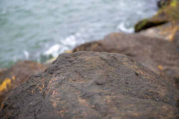 Close-up of a wet stone by the sea