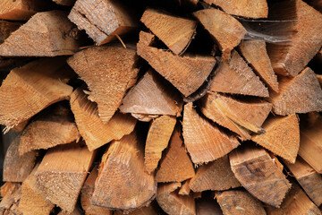Sawn, split and stacked fireplace firewood, background pattern