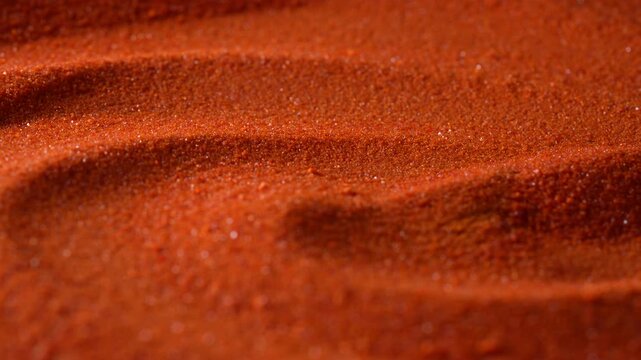 Small bright orange crystals of potassium dichromate, close up, abstract colorful background