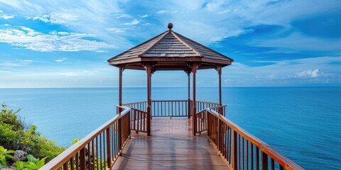 Tranquil wooden gazebo overlooking ocean and blue sky ideal for relaxation concept