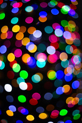 bokeh colorful circle light orange white blue red green color with dark black background 
