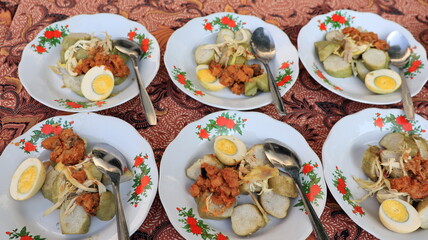 Lontong sayur. Rice cake with vegetable curry and spicy boiled egg