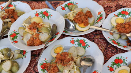Lontong sayur. Rice cake with vegetable curry and spicy boiled egg