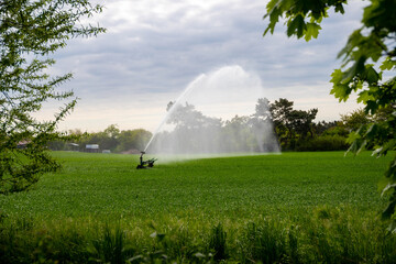 Field with hill and a water cannon irrigating