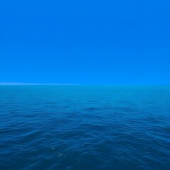 Fototapeta premium The ocean extends into the distance under a clear blue sky in the late evening.