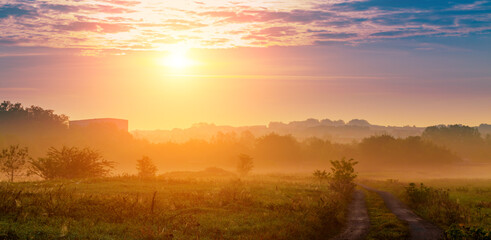 Sunrise Over Misty Field