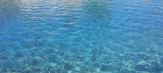 View of pristine, crystal-clear azure sea: vibrant blue waters with an unblemished, tranquil surface