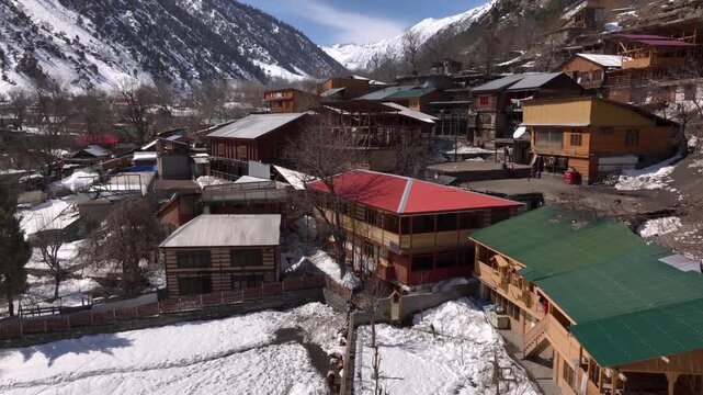 Scenic Kalasha Village in Bamburet Valley in North Pakistan at Winter. Aerial View Hindu Kush Muntain Range Himalayas.