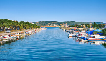 Fototapeta premium Chanakkale, fishing boats stand on the pier, view of the city and the Dardanelles Strait