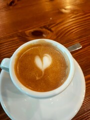Espresso with Heart-Shaped Latte Art in White Cup on Wooden Table
