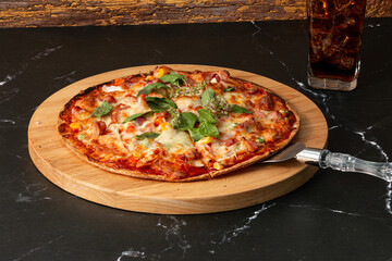 Delicious and appetizing slice of pizza served on a wooden cutting board topped with various...