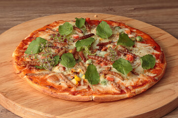 Mouthwatering gourmet insects pizza, freshly baked and beautifully presented on a wooden cutting board. The pizza is adorned with a variety of toppings, including fresh basil leaves,