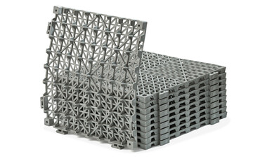 Stack of Anti-slip rubber mats in the bathroom, isolated on white background panels have a grid-like pattern on their surface, providing a sturdy and slip-resistant surface panels are stacked neatly