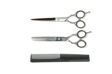 Set of Professional haircutting scissors of high-quality stainless steel with sharp blades and ergonomic finger holes for easy handling for barbers to trim the hair in a salon, on white background