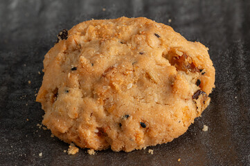 Close-up view of rustic, Delicious cookies containing dried fruits or berries like cranberries or raisins, giving them a rustic, homemade.