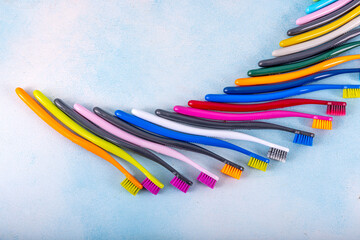 Several multi-colored toothbrushes close-up.  Different multi-colored toothbrushes stock images. Toothbrush on a blue background.  Medicine, dentistry concept. Bathroom accessories images.